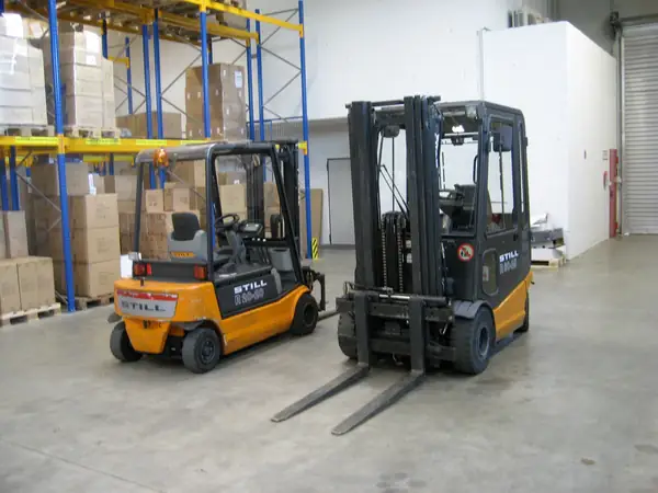 Forklift trucks in a warehouse — illustrative photo