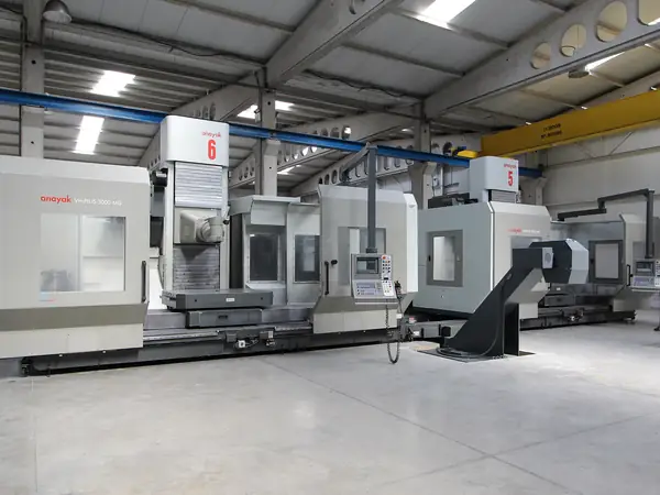 CNC milling machines in a factory hall — illustrative photo