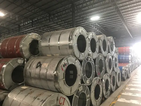 Steel coils stacked in a warehouse — illustrative photo