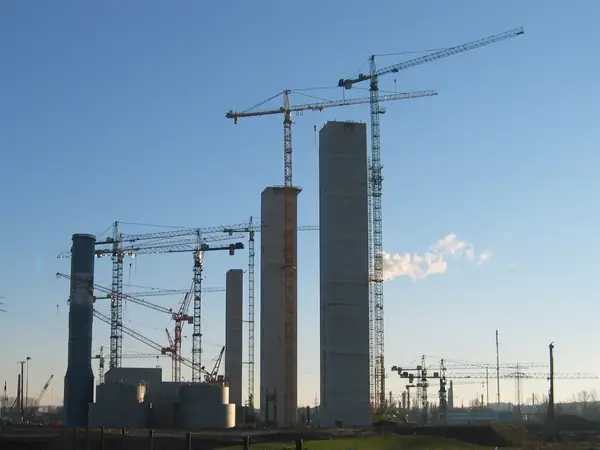 Power plant construction site with tower cranes — illustrative photo